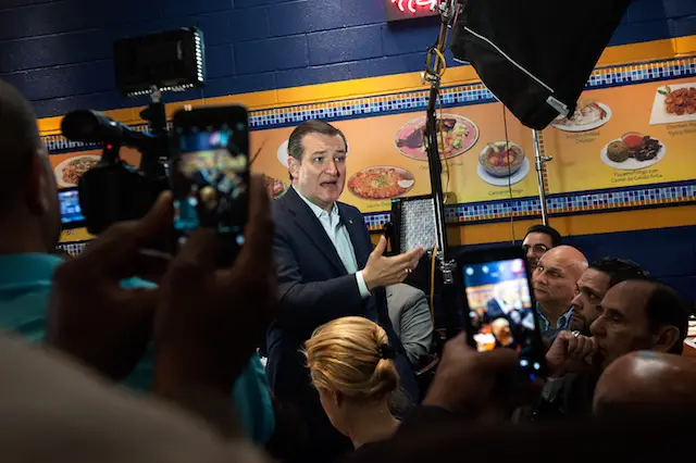Cruz at lunch in the Bronx, likely explaining the menu.